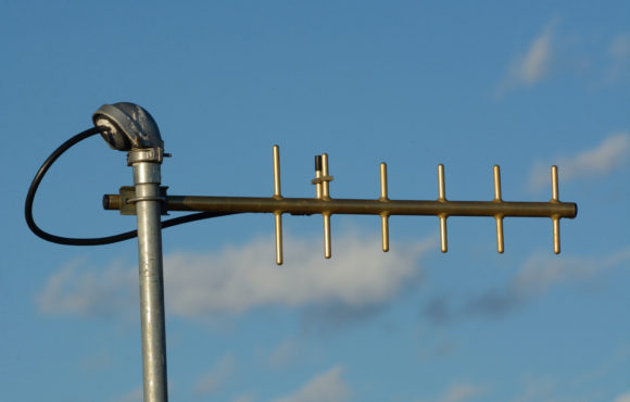 UHF yagi antenna used for digital telemetry data as late afternoon sun setting gives antenna a golden tone